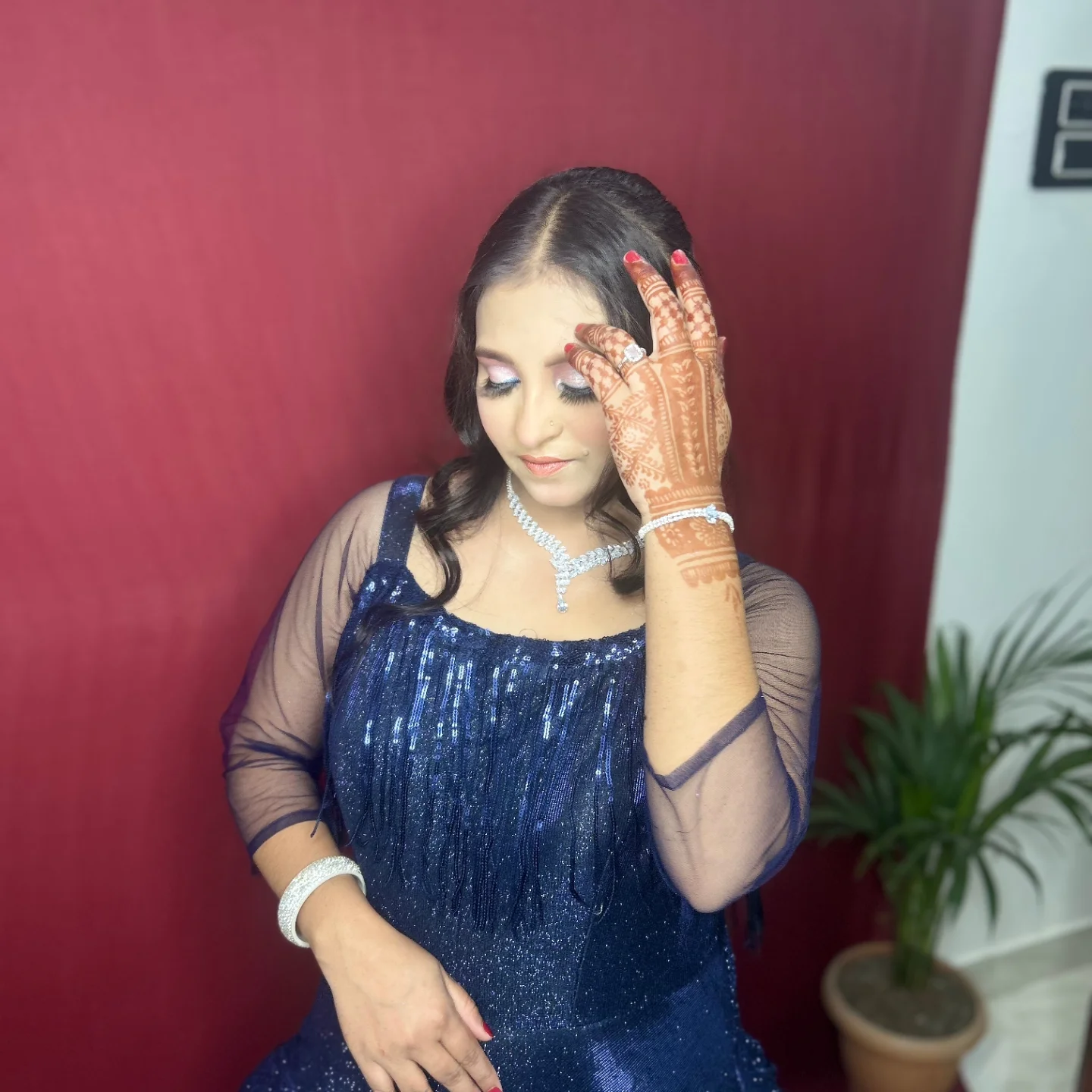 Navy gown party hands on head — Patna